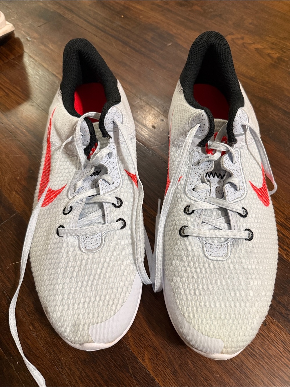 Dingy/stained Nike Men’s White and Red Lightweight Athletic Running Shoes